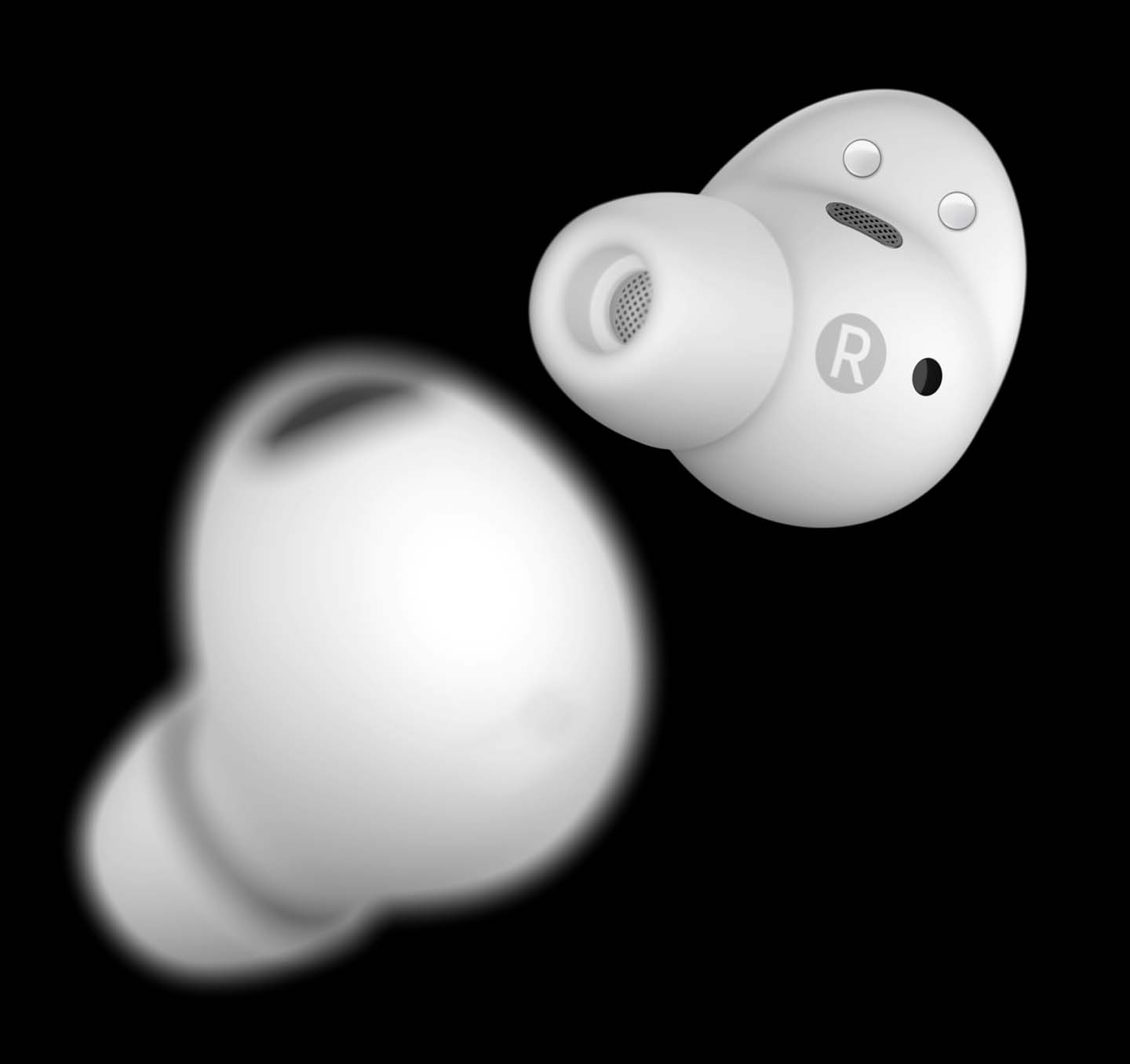 Two White Galaxy Buds2 Pro earbuds placed one in front of the other using a short depth of field to show the front bud clearly while the back bud is blurry.