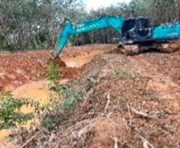 Excavator shaping soil around a water channel as part of a water replenishment project site.