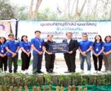 Water replenishment project participants stand in front of a banner during a commemorative event.