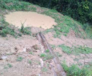 Small retention pond and waterway restoration site on a slope.