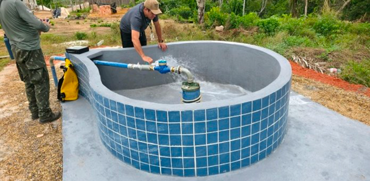 Worker inspects a water replenishment facility inside a circular water tank.