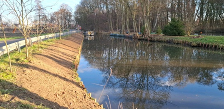 Restored pond and surrounding green area after streambank maintenance.